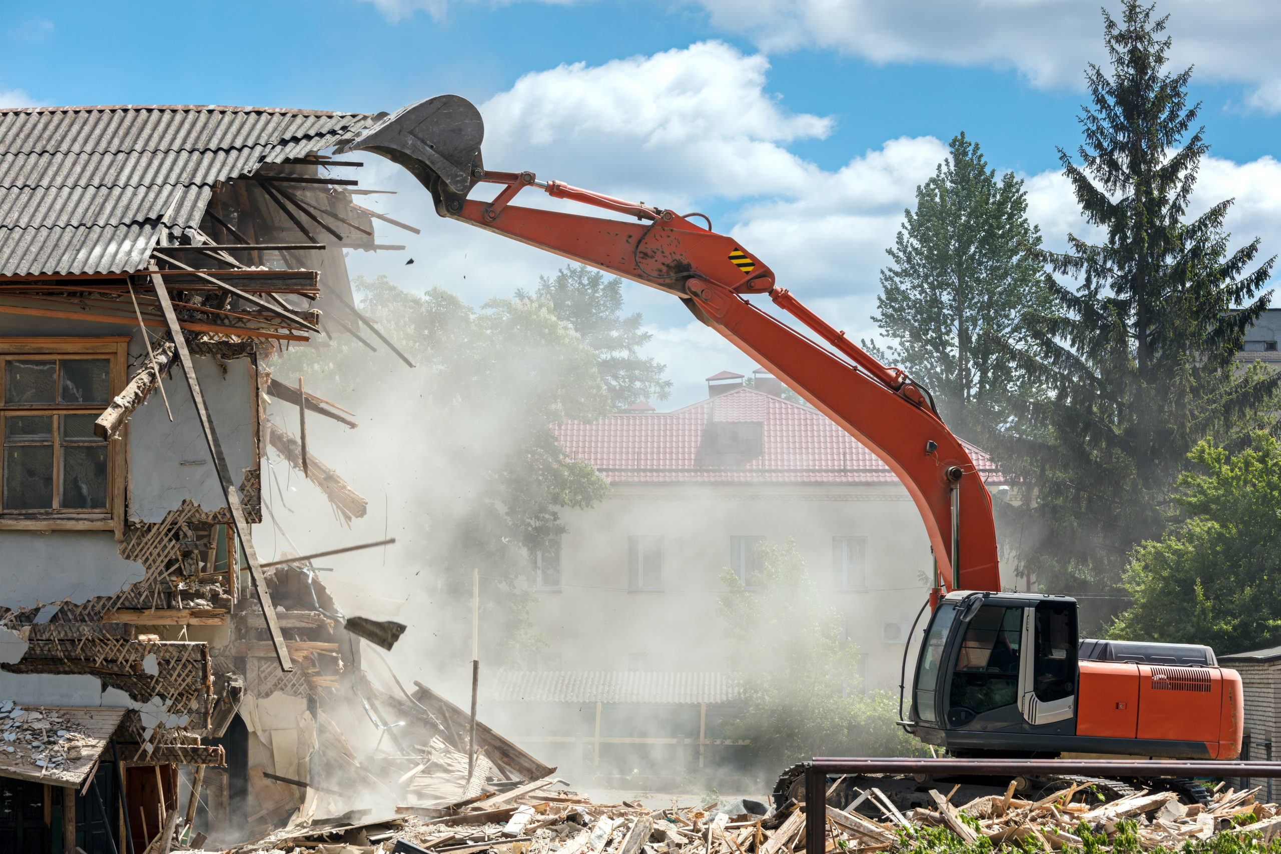 An excavator Demolishing a residential house.