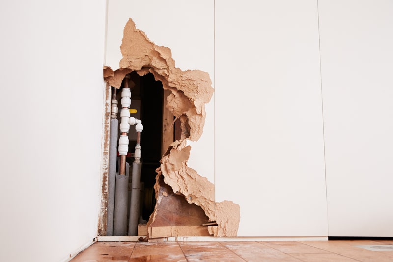 Wall damage from a burst water pipe.