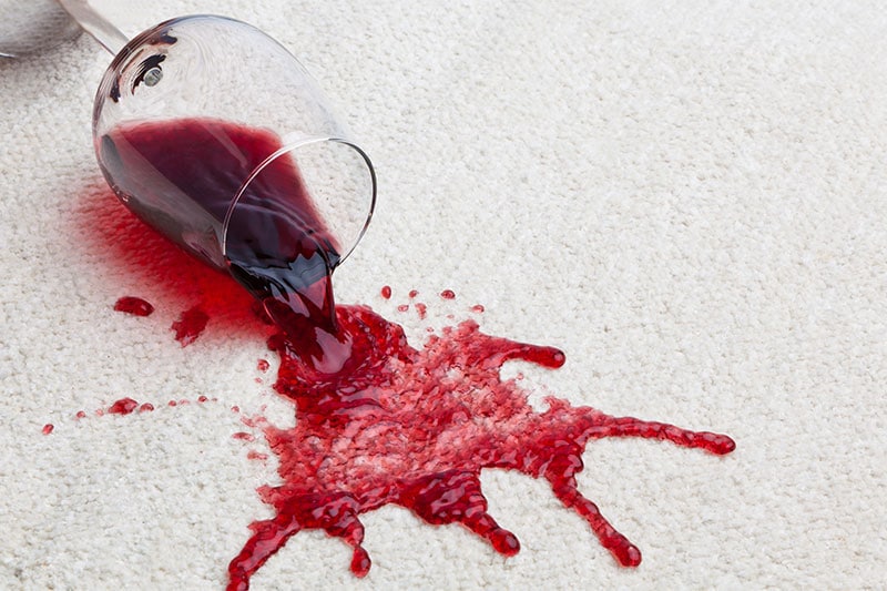 red wine spilt on the carpet showing the stain.